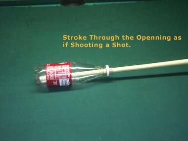 Pool Instruction, Stroke Billiards Cue through bottle opening.